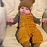 Jude is registered to the contest to win money with this photo: baby, beanie, bodypart, bonnet, cap, clothing, couch, face, finger, furniture, hand, happy, hat, head, knitwear, pants, person, photography, smile, sweater