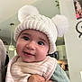Annaliese joined the competition — help win amazing prizes! baby, bib, child, clothing, cozy, cute, face, hand, happy, hat, holding, indoor, infant, kitchen, person, pom_poms, portrait, smile, soft_light, warm