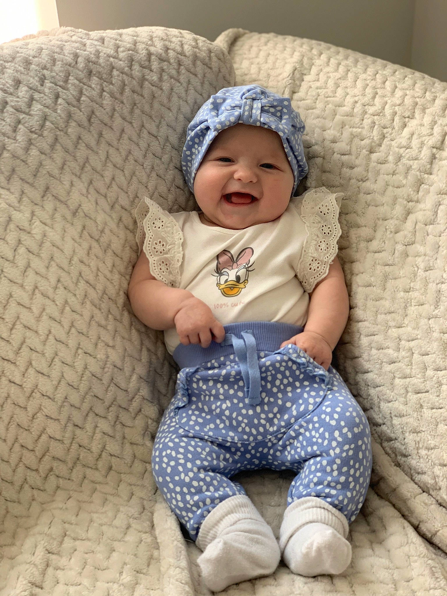 Lennie joined the competition — help win amazing prizes! baby, baby_toddler_clothing, beanie, cap, child, comfort, couch, electric_blue, eye, fashion_accessory, foot, happy, headwear, linens, pattern, person, portrait_photography, sitting, sleeve, smile