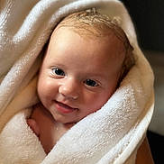 Bodhi joined the competition — help win amazing prizes! baby, infant, towel, smile, face, skin, eyes, hair, wrapped, soft, cute, child, newborn, portrait, happy, warm, cozy, closeup, person, indoors