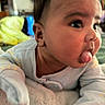 Kyeson is registered to the contest to win money with this photo: baby, tongue, face, closeup, child, pajamas, cheeks, expression, cute, infant, skin, hand, blanket, indoors, person, sleepwear, newborn, toddler, lying_down, playful