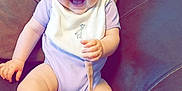 Araia-Louise joined the competition — help win amazing prizes! baby, bib, blue_eyes, child, couch, cute, foot, furniture, giraffe, hand, happy, head, indoor, infant, onesie, pacifier, relaxed, sitting, skin, smiling