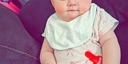 Araia-Louise joined the competition — help win amazing prizes! baby, infant, blue_eyes, onesie, bib, pacifier, red_clip, couch, indoor, child, cute, plump, seated, looking_away, soft_lighting, baby_carrier, fabric_pattern, hand, foot, skin