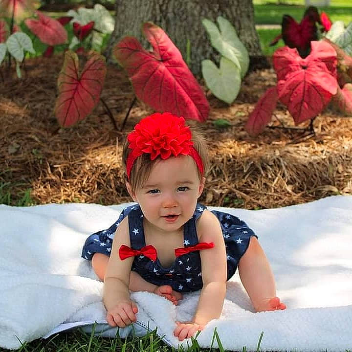 Ansleigh is registered to the contest to win money with this photo: baby, baby_toddler_clothing, beauty, child, fashion_accessory, fun, grass, happy, headband, headpiece, headwear, leaf, leisure, pattern, people_in_nature, person, plant, recreation, sitting, smile