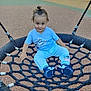 toddler, child, playground, swing, rope_swing, blue_clothing, marvel, sneakers, outdoor, daylight, smile, curly_hair, top_knot, play, fun, park, fence, rope, casual, happy