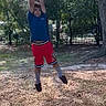 Carlos joined the competition — help win amazing prizes! child, playground, hanging, blue_shirt, red_shorts, outdoor, trees, park, wood_chips, fence, daylight, person, active, exercise, leisure, summer, fun, young, casual_clothing, nature