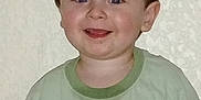 Myles is registered to the contest to win money with this photo: blue_eyes, casual_clothing, child, cute, expression, face, green_shirt, happy, head_and_shoulders, indoor, light_skin, person, portrait, short_hair, smiling, standing, striped_shirt, toddler, wall, young_child