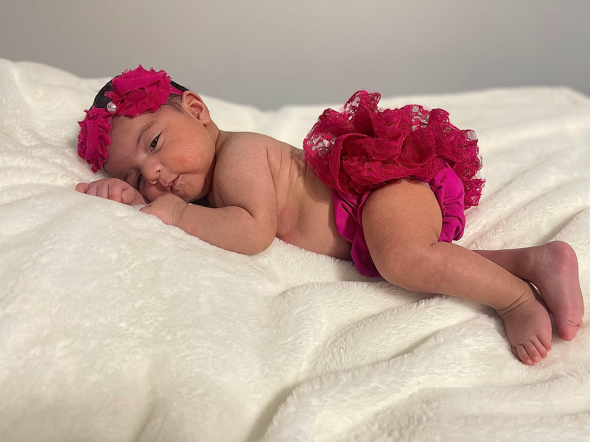 Aleyna is registered to the contest to win money with this photo: baby, baby_sleeping, baby_toddler_clothing, bed, bedding, child, comfort, eye, hair_accessory, head, headgear, headwear, human_body, linens, magenta, person, petal, pink, skin, textile