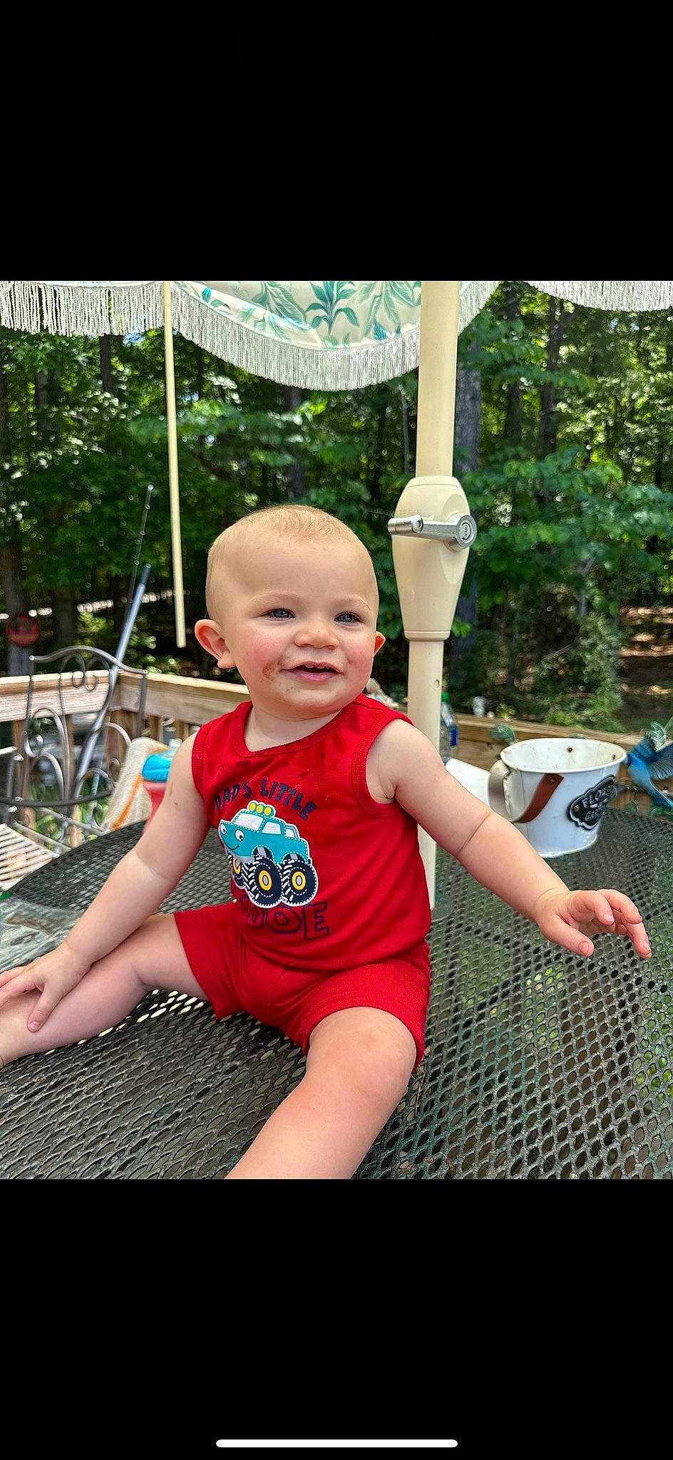 Ledger is registered to the contest to win money with this photo: baby, baby_toddler_clothing, child, fun, garden, grass, happy, joy, leisure, magenta, person, pink, plant, recreation, sitting, smile, t_shirt, tire, toddler, tree