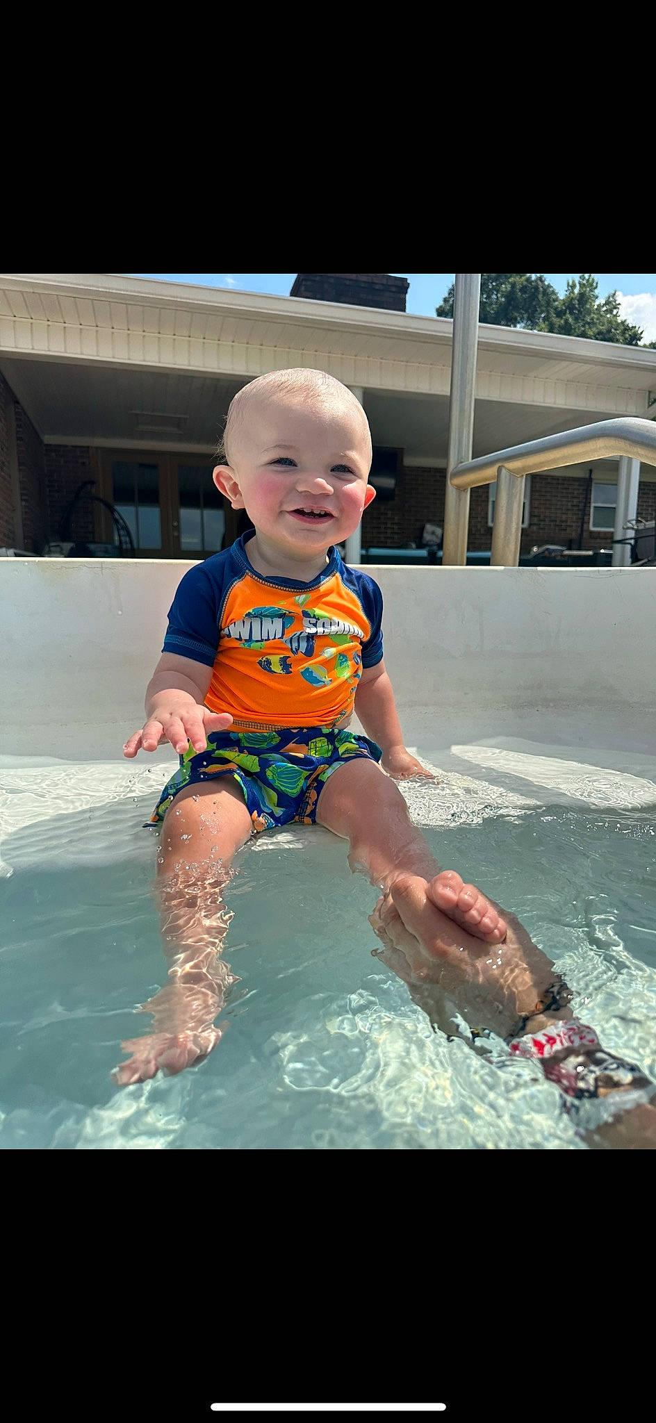 Ledger is registered to the contest to win money with this photo: baby, baby_toddler_clothing, bathing, child, fun, happy, inflatable, joy, leisure, leisure_centre, person, personal_protective_equipment, play, recreation, sky, smile, summer, swimming_pool, swimwear, toddler