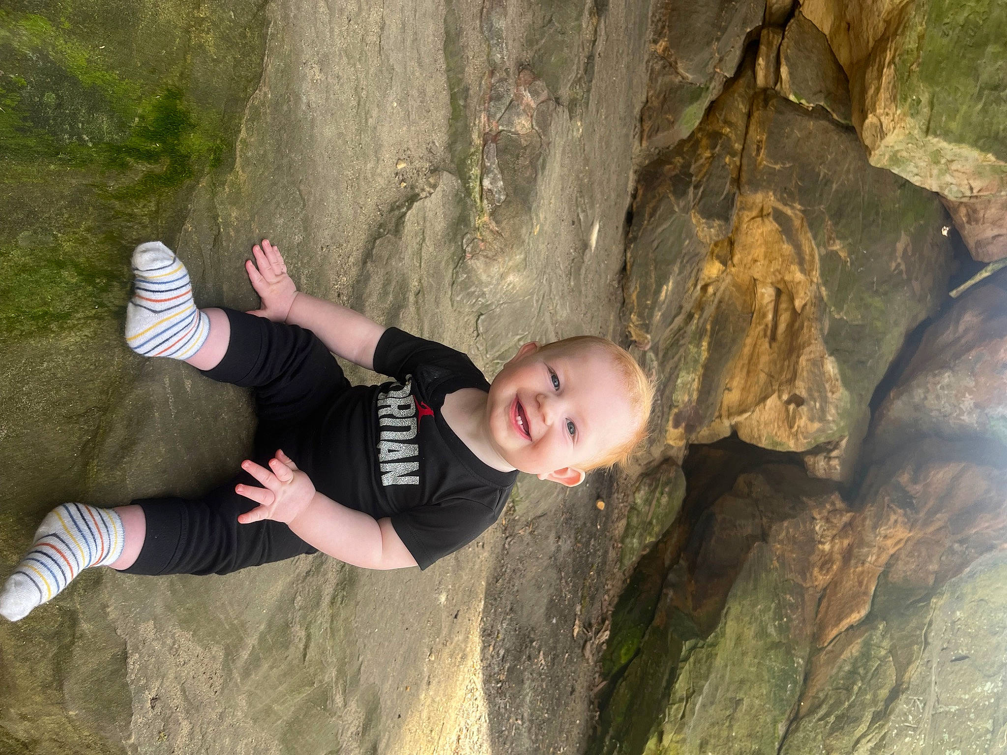 Lincoln is registered to the contest to win money with this photo: adventure, bedrock, flash_photography, fun, geology, grass, happy, joy, knee, leaf, leisure, people_in_nature, person, plant, recreation, soil, sport_climbing, t_shirt, thigh, tree