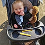 Rae joined the competition — help win amazing prizes! baby, stroller, plush_toy, monkey, cheese_sticks, snack, child, blue_eyes, black_jacket, sneakers, outdoor, sunlight, shadow, happy, smiling, seat_belt, fabric, plastic_tray, footwear, person