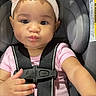 Sekari is registered to the contest to win money with this photo: baby, car_interior, car_seat, child, close_up, earrings, face, flower_headband, hands, indoors, infant, photography, pink_clothing, portrait, pouting, safe, safety_harness, sitting, vehicle, wide_eyes