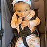 Sekari is registered to the contest to win money with this photo: baby, baby_gear, bow, child, curious, face, floral_pants, hands, harness, headband, indoors, infant, photography, pink_clothing, portrait, safe, seatbelt, sitting, stroller, transportation