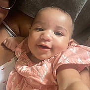 Sekari is registered to the contest to win money with this photo: adult, baby, child, close_up, couch, dress, eyes, fabric, face, glasses, happy, indoor, infant, mouth, person, photography, pink_outfit, portrait, selfie, smiling