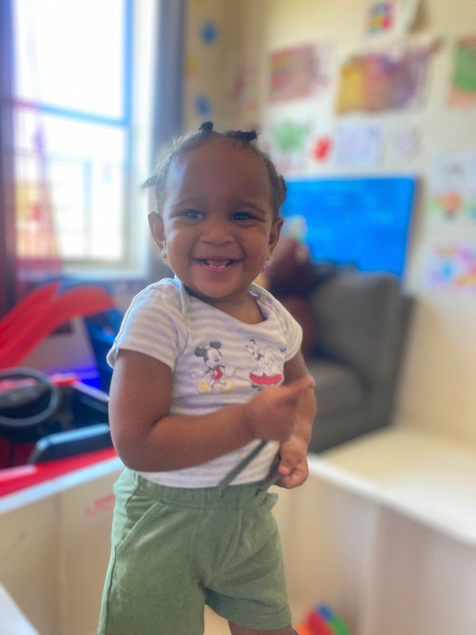 Luca is registered to the contest to win money with this photo: baby, baby_playing_with_toys, baby_toddler_clothing, cheek, child, fun, happy, joy, kindergarten, leisure, person, play, recreation, room, shorts, sitting, smile, standing, t_shirt, toddler