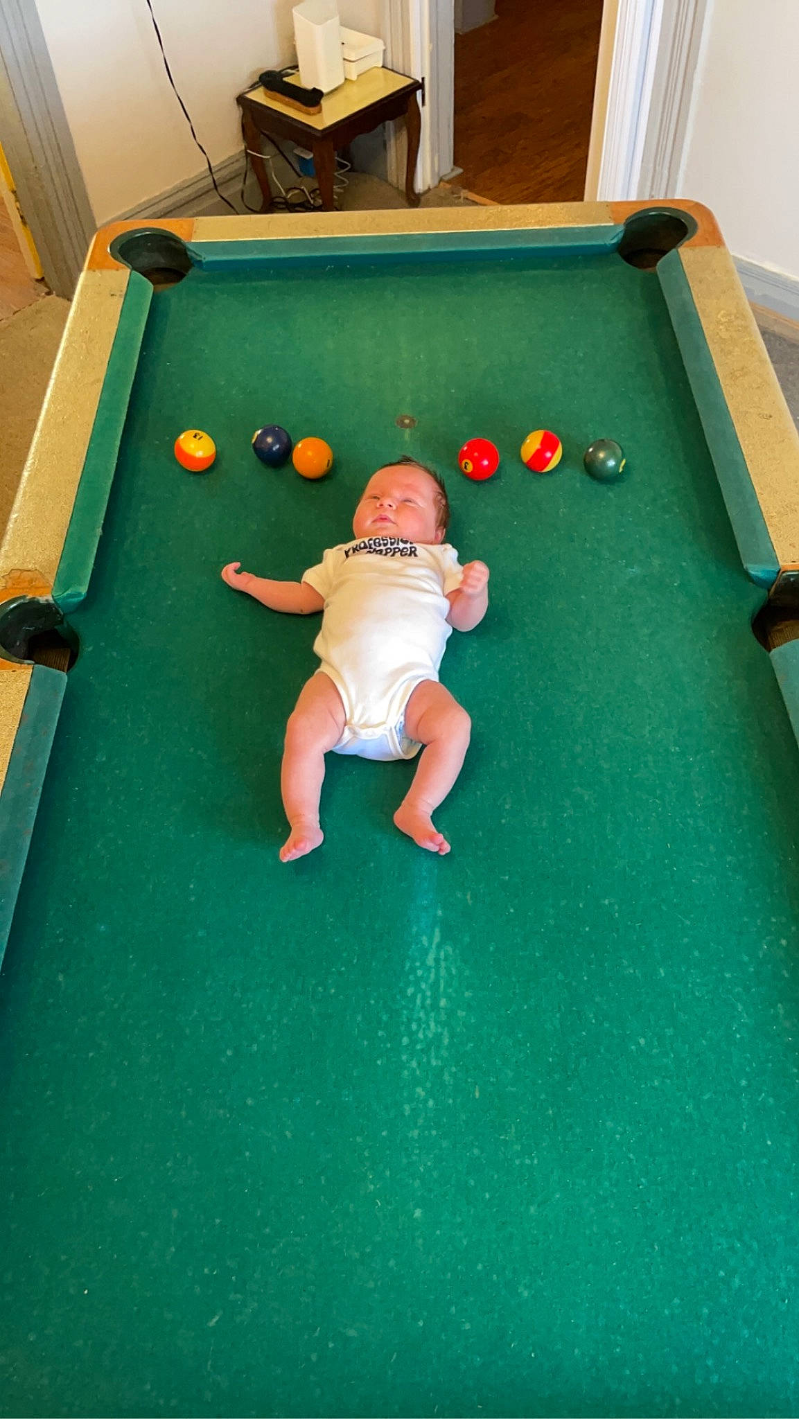 Alexandria is registered to the contest to win money with this photo: baby, baize, ball, billiard_ball, billiard_room, billiard_table, billiards, clothing, fun, grass, human_body, indoor_games_and_sports, leisure, person, playground, pool, recreation, recreation_room, sports_equipment, straight_pool