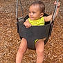 toddler, child, swing, playground, outdoor, yellow_clothing, barefoot, wood_chips, seat, metal_chain, baby, fun, recreation, summer, park, happy, person, young_child, activity, smiling