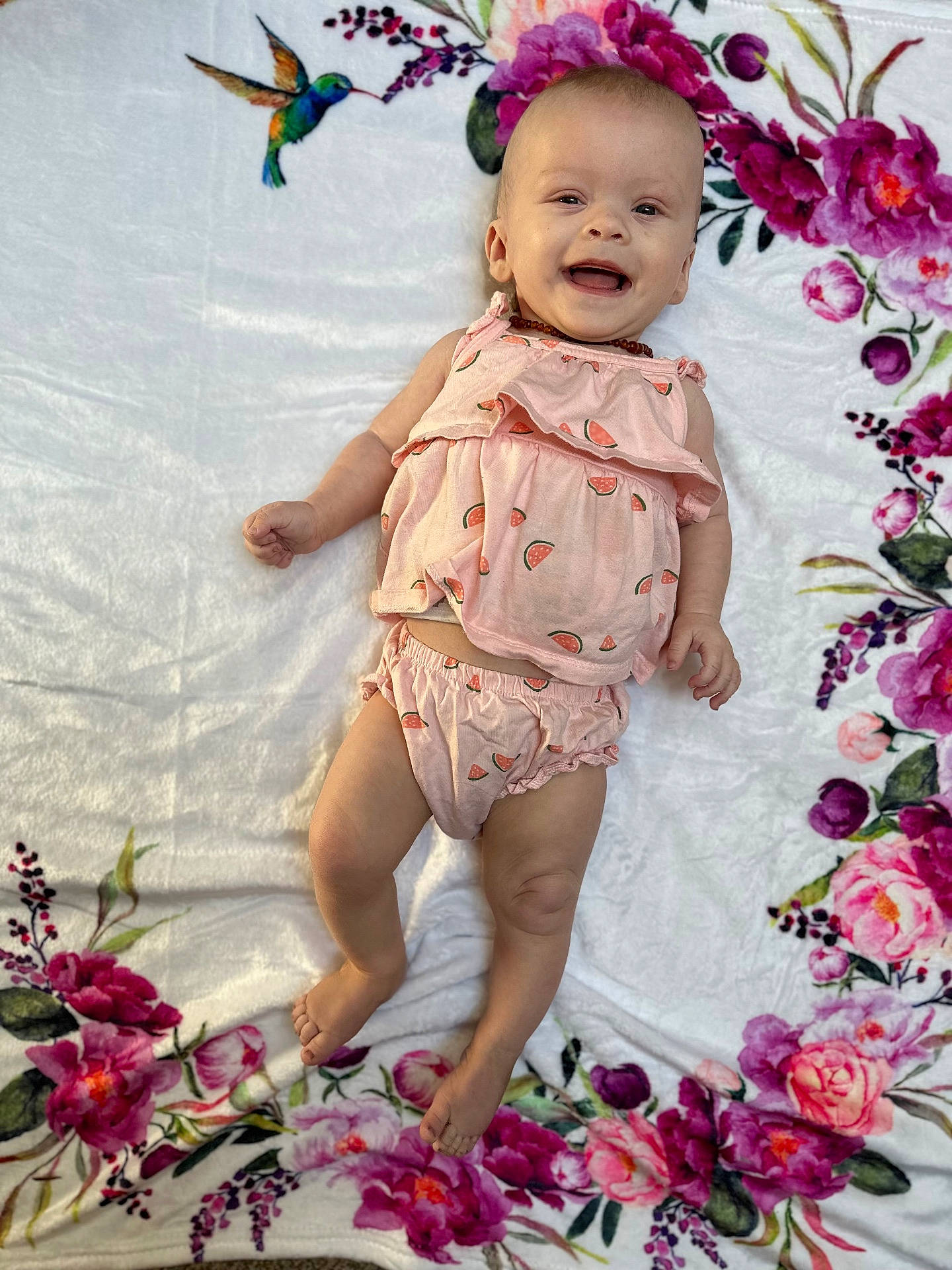 Rosie is registered to the contest to win money with this photo: baby, clothing, cushion, dress, face, flower, furniture, happy, head, homedecor, person, petal, photography, plant, portrait, quilt, rose, sitting, sleeve, standing