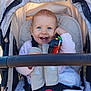 Zoé participe au concours pour gagner de l'argent avec cette photo : baby, child, stroller, toy, smile, blue_eyes, blanket, harness, buckle, seat, canopy, pink_sweater, hand, teeth, grasping, outdoor, sunlight, portrait, toddler, happy