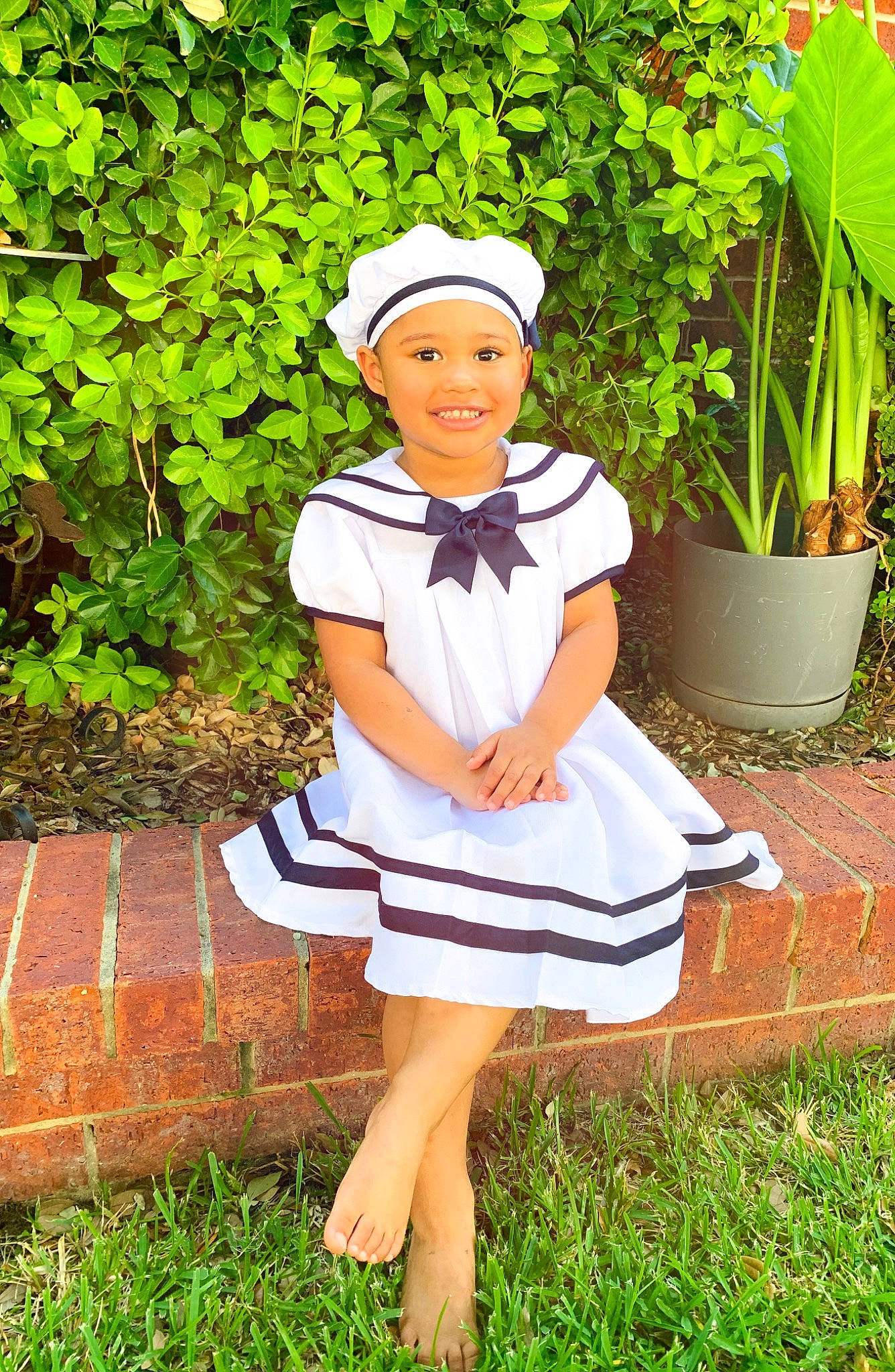 Khalia joined the competition — help win amazing prizes! cap, child, child_model, clothing, costume, dress, grass, happy, headgear, headwear, joy, person, photo_shoot, photography, school_uniform, sitting, uniform