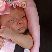 Jeanie-Marie is registered to the contest to win money with this photo: baby, infant, pink_bow, blanket, car_seat, child, face, headwear, straps, soft_texture, adorable, small_hand, clothing, portrait, newborn, cute, resting, indoors, closeup, skin