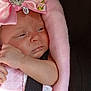 baby, infant, pink_bow, blanket, car_seat, child, face, headwear, straps, soft_texture, adorable, small_hand, clothing, portrait, newborn, cute, resting, indoors, closeup, skin