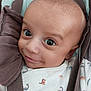 baby, infant, face, eyes, smile, car_seat, straps, clothing, onesie, dinosaur_print, cute, child, portrait, close_up, skin, head, expression, happy, seated, young