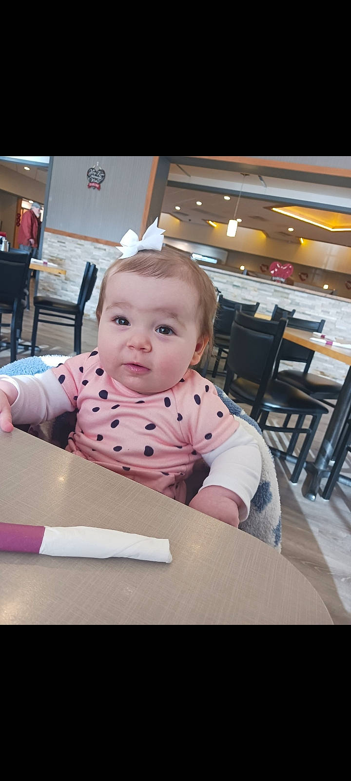 Oriyah joined the competition — help win amazing prizes! baby, baby_toddler_clothing, chair, child, eye, flooring, happy, kitchen_dining_room_table, person, portrait_photography, room, sitting, smile, t_shirt, table, toddler