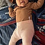 baby, infant, child, bed, blanket, pillow, clothing, pink_pants, brown_top, lying_down, indoors, soft_toys, fuzzy, relaxed, cute, person, portrait, cozy, infant_clothing, sleepwear