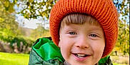 Kol joined the competition — help win amazing prizes! child, smiling, green_jacket, orange_hat, teddy_bear, outdoor, park, trees, grass, autumn, happy, cute, warm_clothing, boy, nature, daylight, portrait, face, childhood, playful