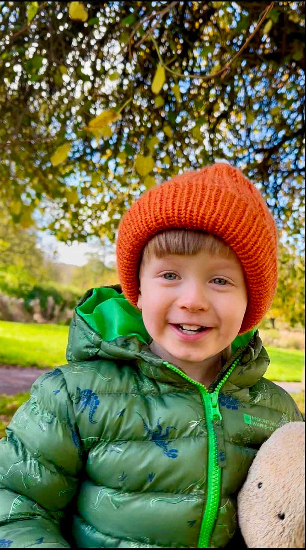Kol joined the competition — help win amazing prizes! child, smiling, green_jacket, orange_hat, teddy_bear, outdoor, park, trees, grass, autumn, happy, cute, warm_clothing, boy, nature, daylight, portrait, face, childhood, playful