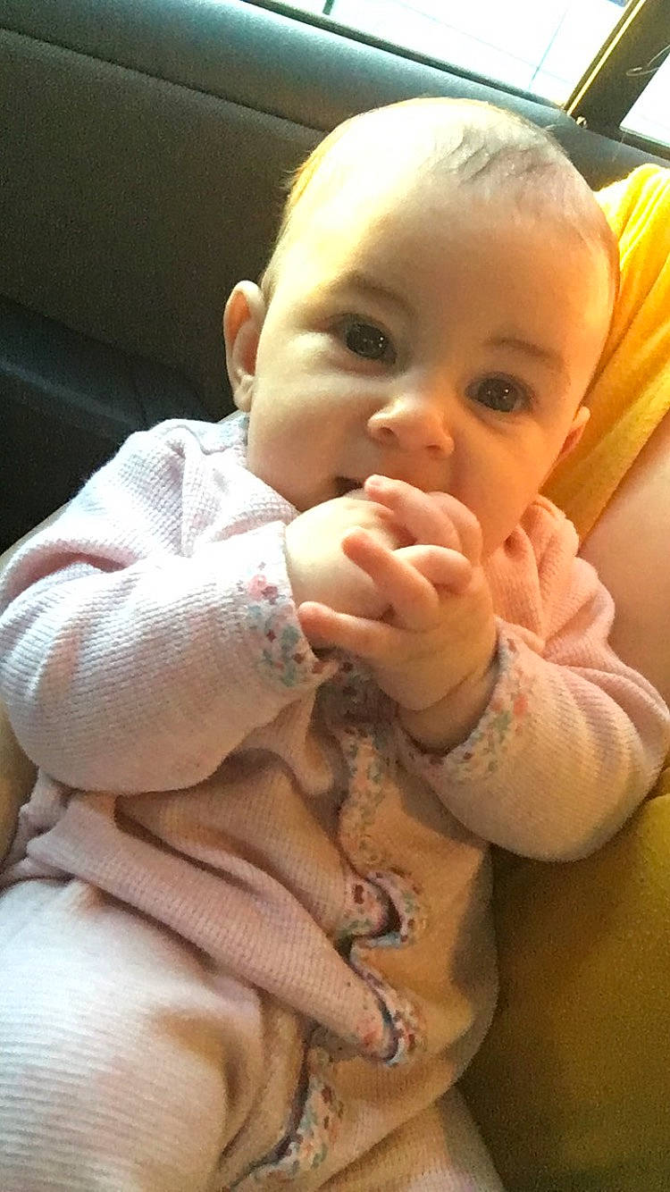 Everleigh is registered to the contest to win money with this photo: baby, cheek, child, finger, joy, mouth, nose, person, skin, thumb, toddler