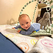 Aryn is registered to the contest to win money with this photo: baby, infant, striped_onesie, blanket, smiley_faces, baby_gym, plush_elephant, toy, floor, indoor, child, tummy_time, play, happy, cute, person, soft_toys, furniture, home, warm_lighting