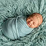 newborn, baby, smiling, sleeping, wrapped, blanket, headband, star, soft, teal, texture, fluffy, cozy, portrait, child, infant, cute, resting, peaceful, photography