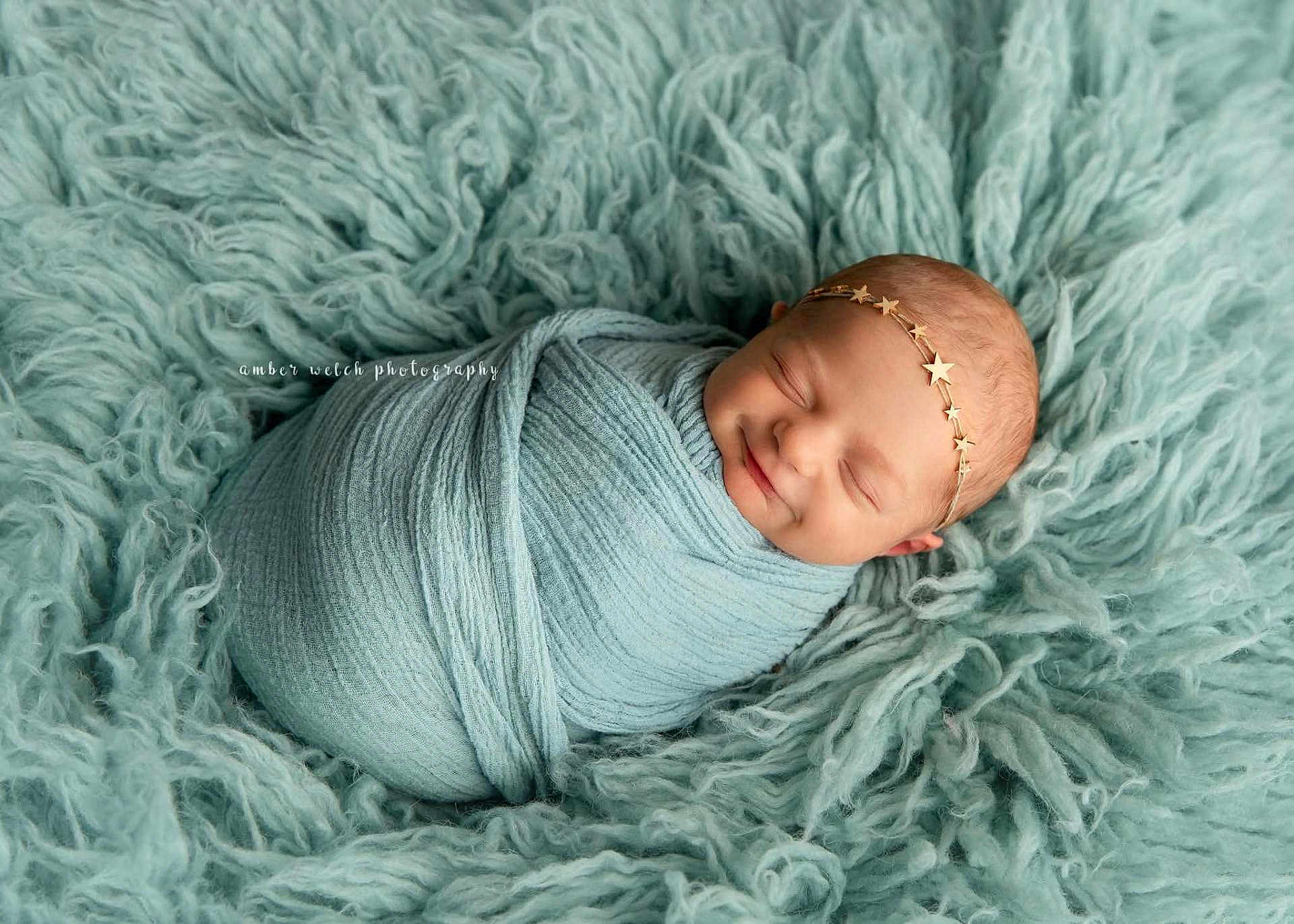 Nova is registered to the contest to win money with this photo: newborn, baby, smiling, sleeping, wrapped, blanket, headband, star, soft, teal, texture, fluffy, cozy, portrait, child, infant, cute, resting, peaceful, photography