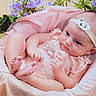 Amandine participe au concours pour gagner de l'argent avec cette photo : baby, basket, child, cushion, cute, feet, flowers, hands, headband, indoor, infant, newborn, person, pink_clothing, portrait, purple_flowers, resting, skin, soft_fabric, yellow_flowers