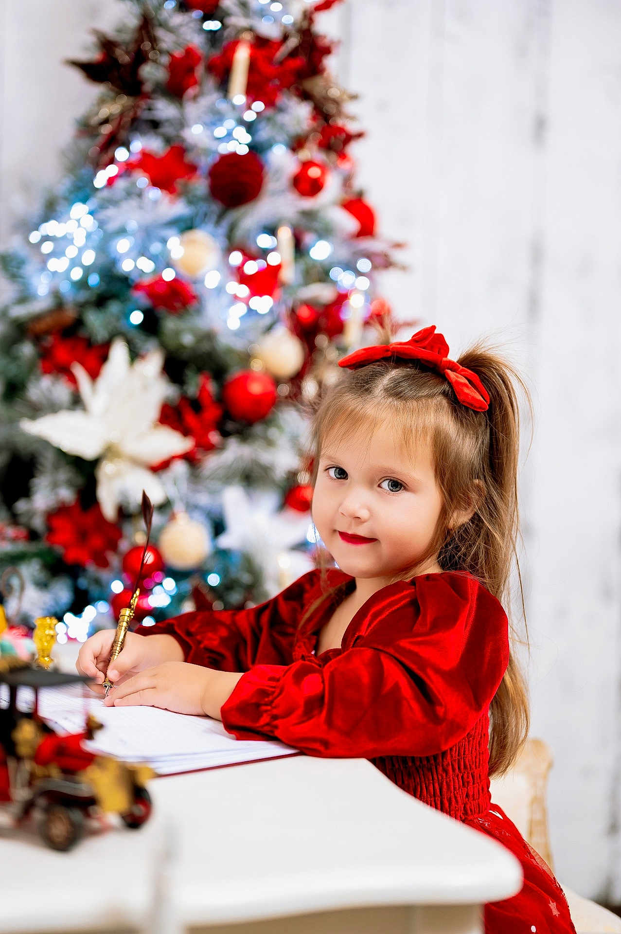 Nicole joined the competition — help win amazing prizes! child, girl, red_dress, christmas_tree, holiday, decorations, writing, desk, quill, festive, smile, long_hair, ribbon, indoors, celebration, seasonal, portrait, happy, festivity, toy_car