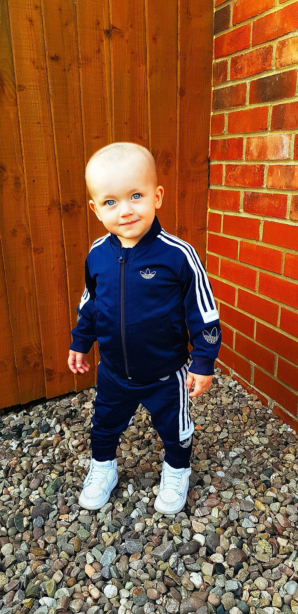 Nathan is registered to the contest to win money with this photo: child, child_model, electric_blue, jacket, jeans, joy, outerwear, person, shoe, sleeve, sportswear, standing, toddler