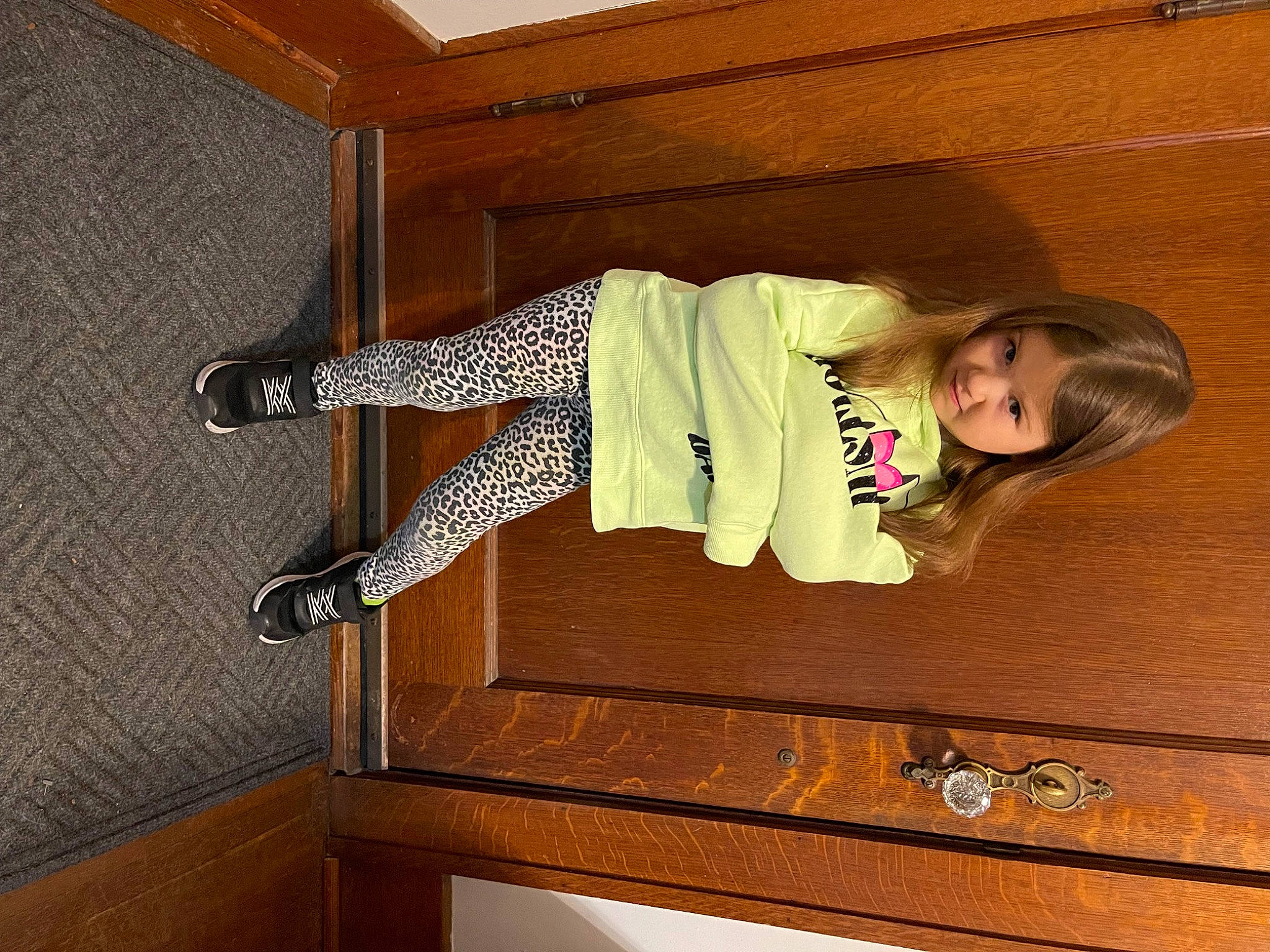 Xiomara joined the competition — help win amazing prizes! baby_toddler_clothing, child, comfort, flooring, happy, hardwood, human_leg, knee, person, room, shoe, sleeve, smile, sportswear, sunglasses, t_shirt, thigh, toddler, varnish, waist