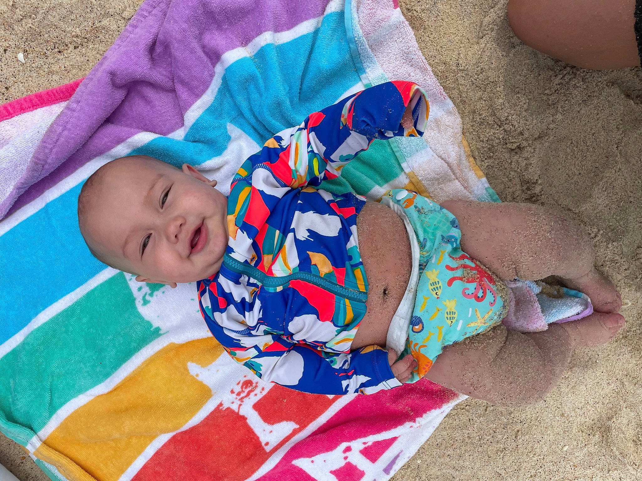 Vincent is registered to the contest to win money with this photo: baby, baby_products, baby_toddler_clothing, child, comfort, electric_blue, fun, grass, happy, human, human_leg, linens, pattern, person, play, sitting, sleeve, smile, summer, textile