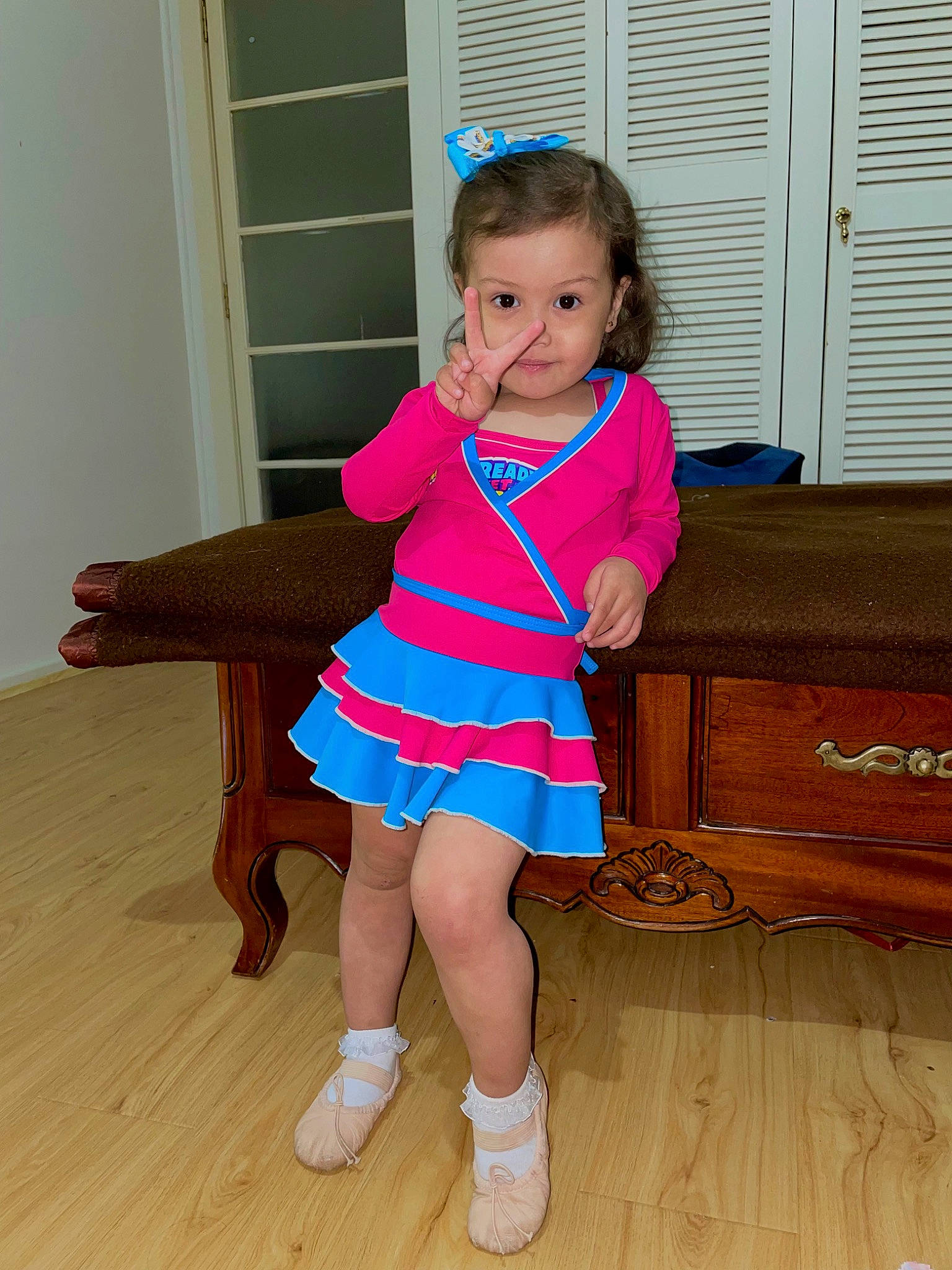 Beatrice is registered to the contest to win money with this photo: baby_toddler_clothing, door, dress, electric_blue, flooring, foot, hardwood, human_leg, joint, knee, leg, person, shoe, sleeve, sock, standing, thigh, thumb, toddler, waist