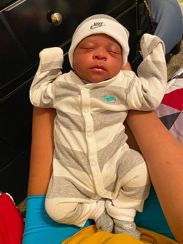 Damarion joined the competition — help win amazing prizes! baby, baby_carriage, baby_toddler_clothing, baseball_cap, cap, child, comfort, finger, fun, green, happy, headwear, leisure, mouth, people, person, recreation, sitting, sleeve, t_shirt