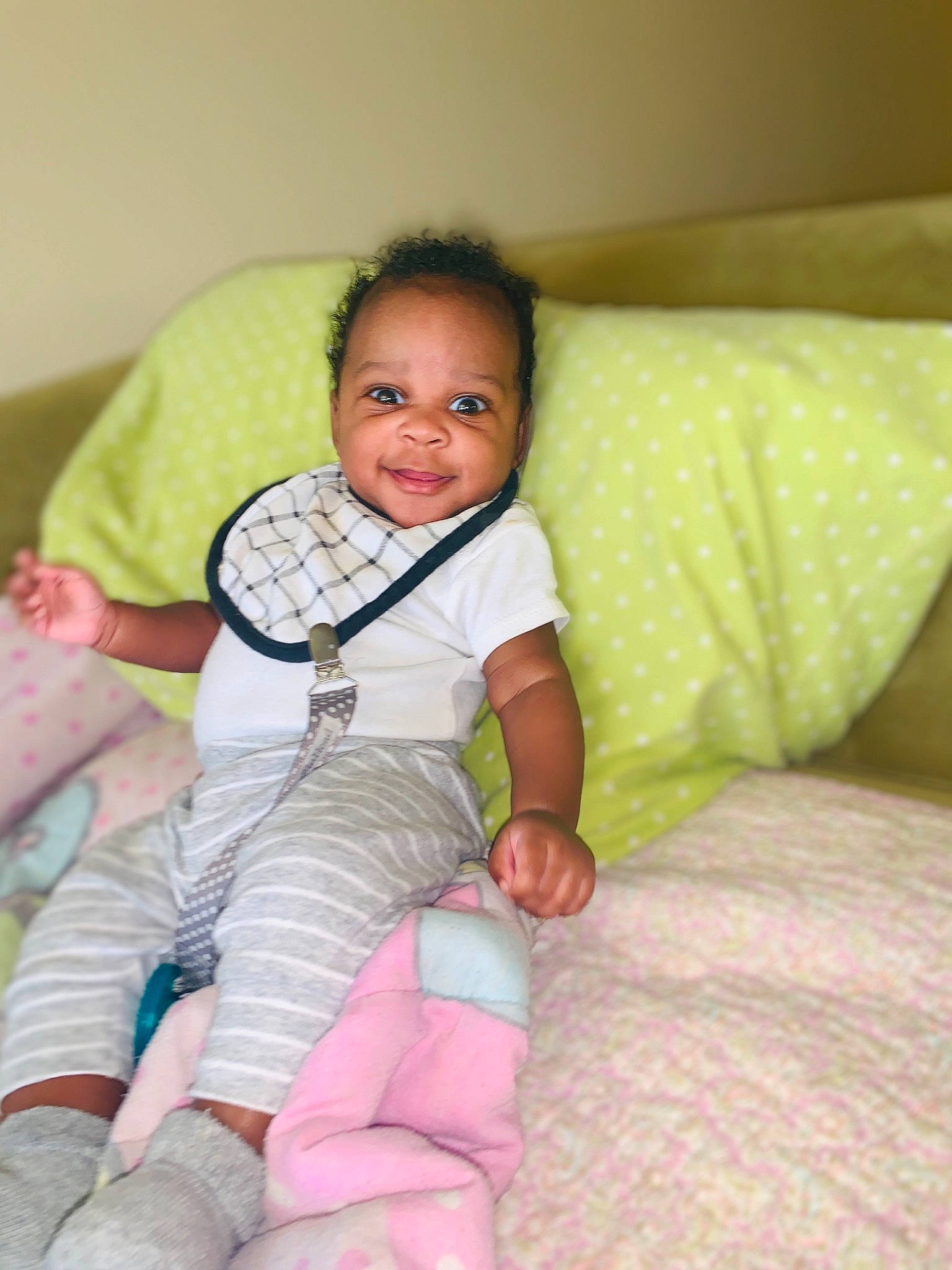 Damarion is registered to the contest to win money with this photo: baby, baby_toddler_clothing, cheek, child, comfort, couch, finger, foot, fun, happy, human_leg, joy, lap, person, sitting, skin, sleeve, smile, sock, textile