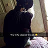 cat, black_and_white, sitting, indoor, wall, light_switch, patterned_surface, pet, feline, whiskers, ears, cute, animal, domestic_cat, looking_back, shadow, snapchat, text_overlay, funny, candid