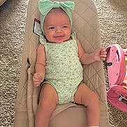 Everleigh is registered to the contest to win money with this photo: baby, infant, smiling, onesie, headband, baby_seat, carpet, toy, pink, mint_green, happy, child, indoor, comfort, sock, cute, soft, relaxed, portrait, young