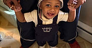 Dreko joined the competition — help win amazing prizes! adult, baby, child, floor, footwear, happy, hat, holding_hands, indoor, joyful, overalls, pants, person, portrait, smiling, support, tattoo, toddler, watch, white_shoes