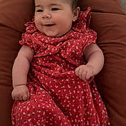 Jade participe au concours pour gagner de l'argent avec cette photo : arm, baby, child, comfort, cozy, cushion, cute, face, floral_pattern, hand, happy, head, indoor, infant, person, red_dress, seated, skin, smile, soft_lighting