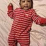 Jamir is registered to the contest to win money with this photo: baby, bed, child, cute, face, footed_pajamas, head, indoors, infant, lying_down, onesie, person, quilt, red_stripes, skin, sleepwear, smile, soft_fabric, striped_clothing, young_child