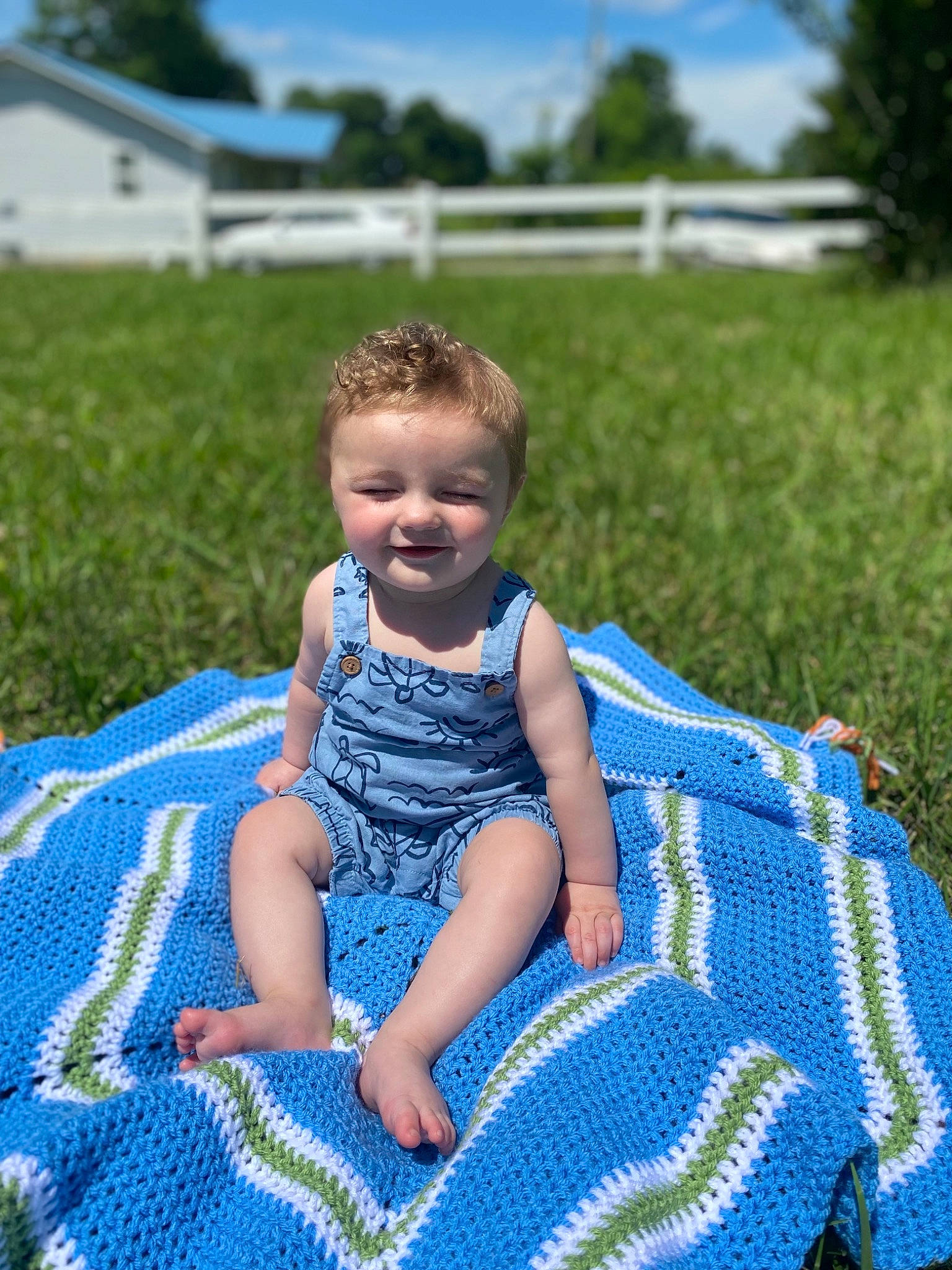 Maxton is registered to the contest to win money with this photo: azure, baby, baby_toddler_clothing, blue, child, dress, electric_blue, grass, grassland, happy, joy, leisure, meadow, pattern, people_in_nature, person, plant, sky, smile, summer
